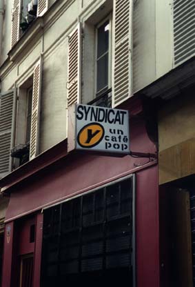  Façade d'immeuble avec enseigne de bar«Syndicat Y, un café POP».